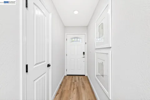 a view of a hallway with wooden floor