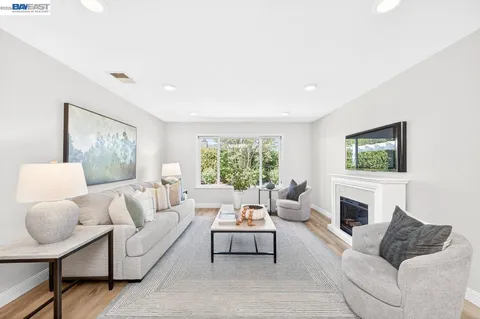 a living room with furniture fireplace and window