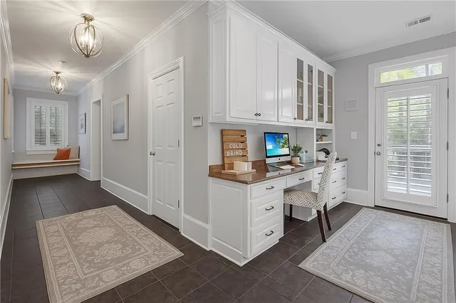 a view of a hallway with wooden floor and entryway