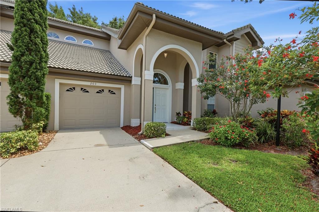 203 Via Perignon, Unit 24 Naples, FL 34119 - Photo 41 of 42 Front of Coach home beautifully landscaped community pool is just across the street