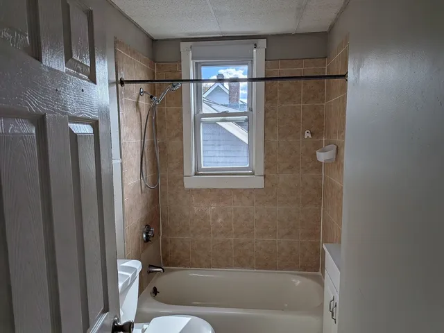 a bathroom with a shower and a bathtub