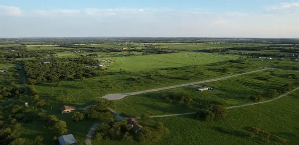 a view of a field with an ocean