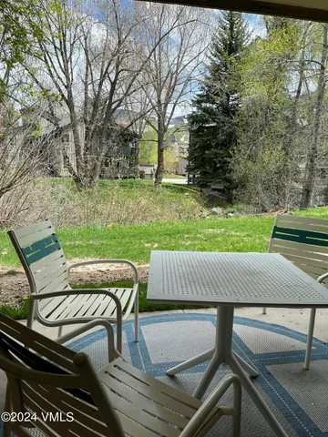 a view of a yard with furniture and a table