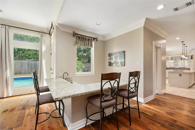 a view of a dining room with furniture and a window