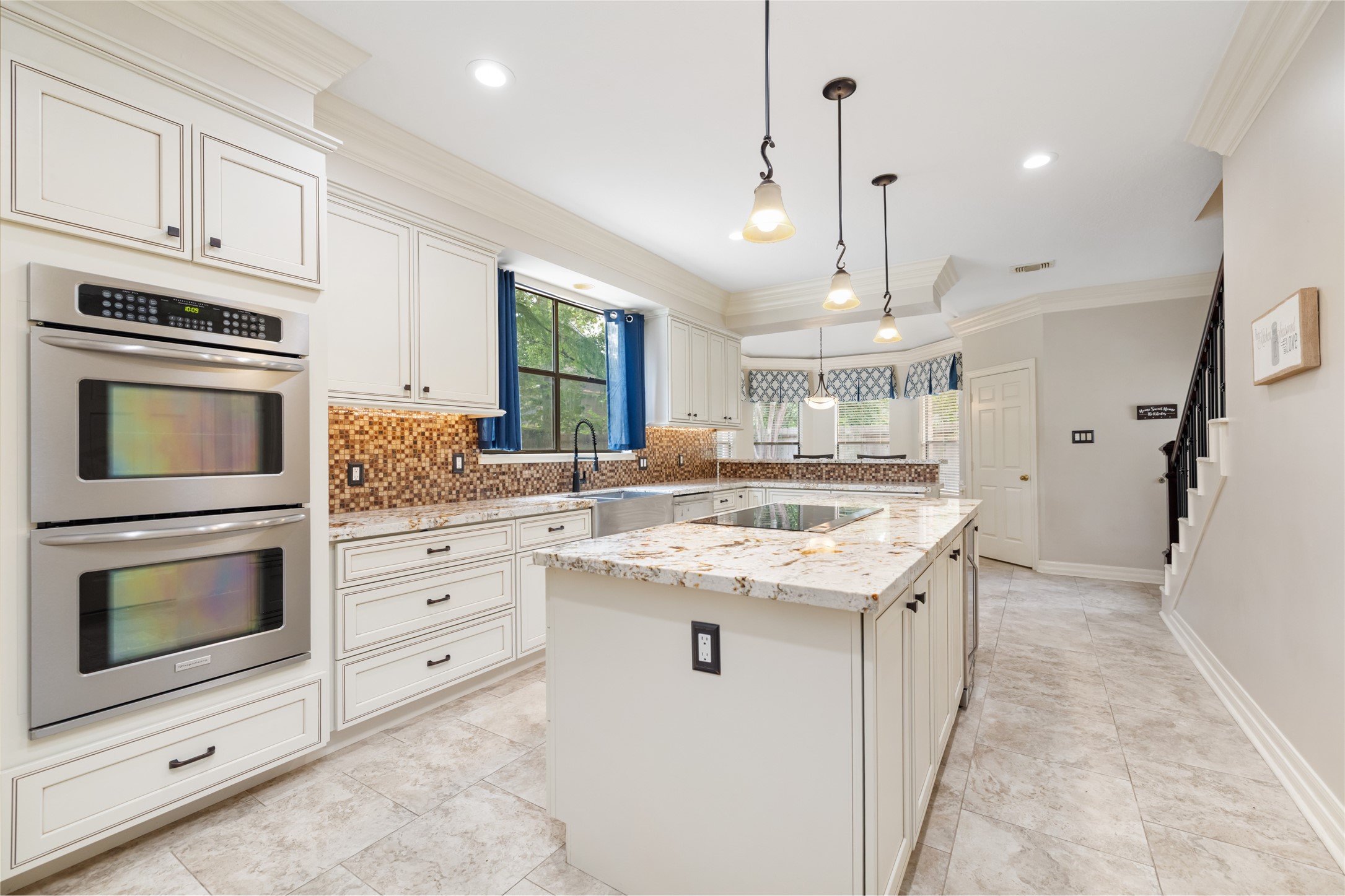 3106 Rustling Moss Drive Houston, TX 77068 - Photo 17 of 45 a kitchen with kitchen island granite countertop a stove oven and a sink with cabinets