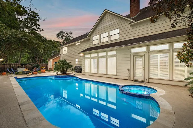 a view of a house with swimming pool and sitting area