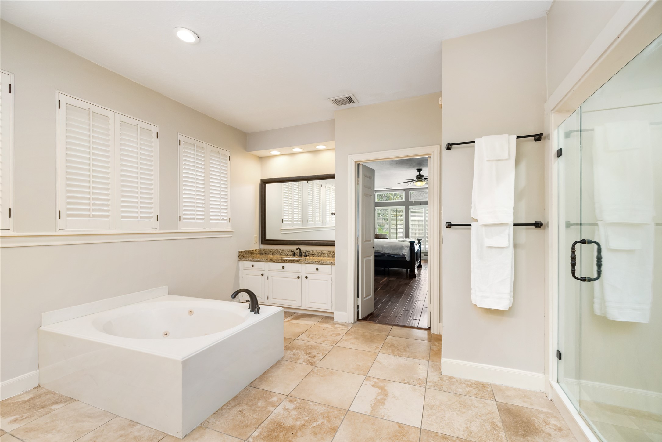 3106 Rustling Moss Drive Houston, TX 77068 - Photo 25 of 45 a bathroom with a tub a window and a shower