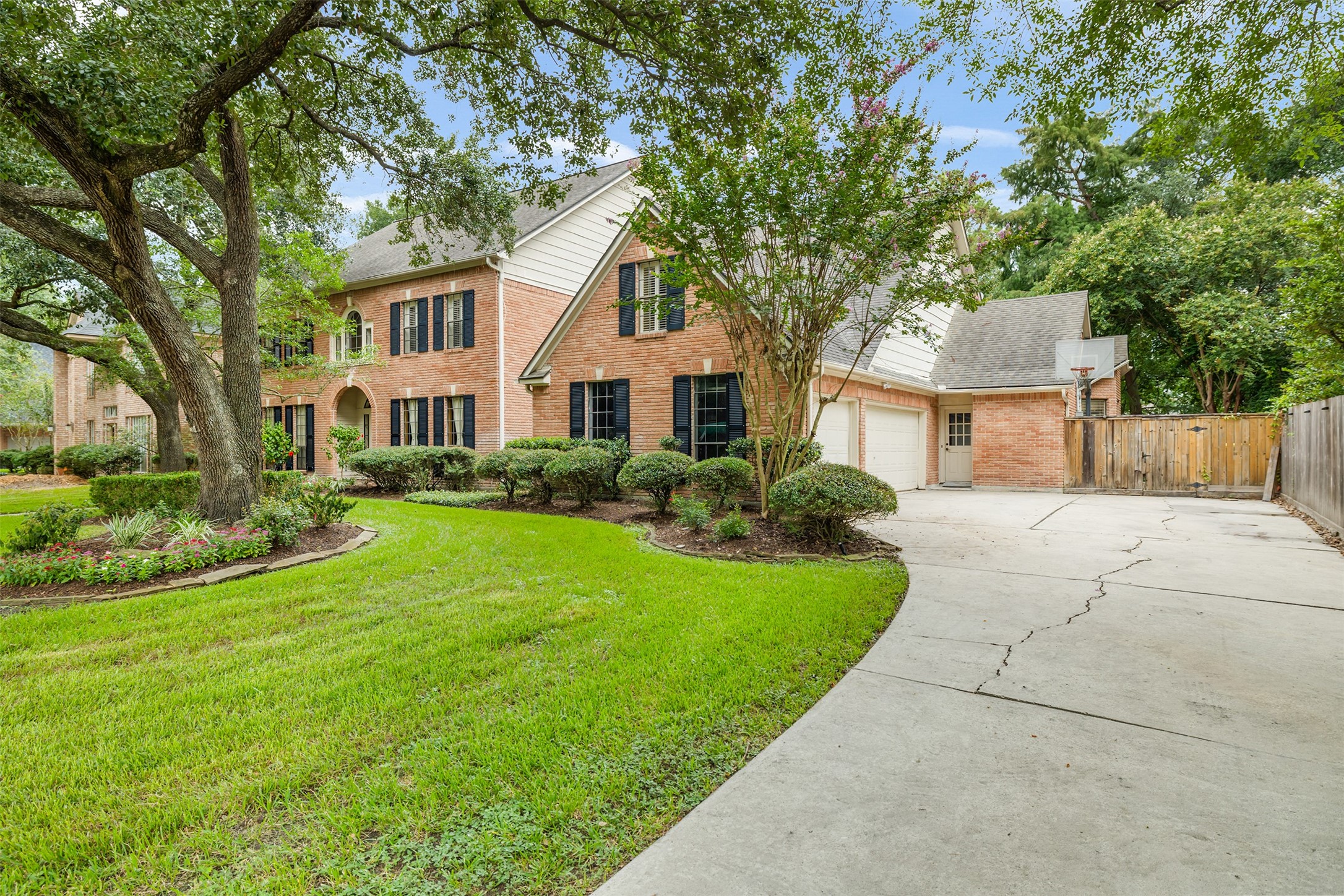 3106 Rustling Moss Drive Houston, TX 77068 - Photo 6 of 45 a front view of a house with a yard and trees