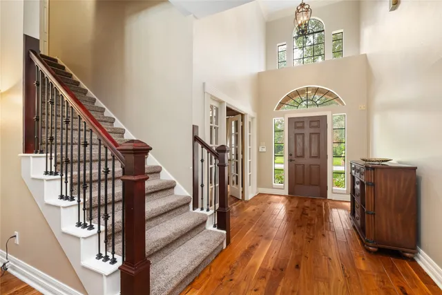 a view of entryway and hall with wooden floor