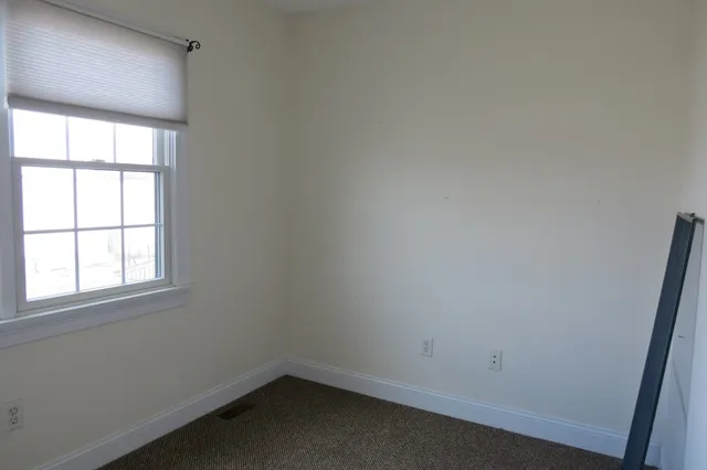 a view of a balcony with wooden floor