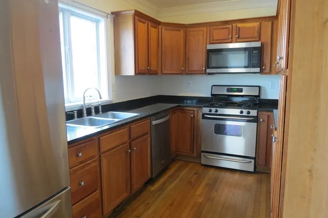 a kitchen with sink a microwave and stove