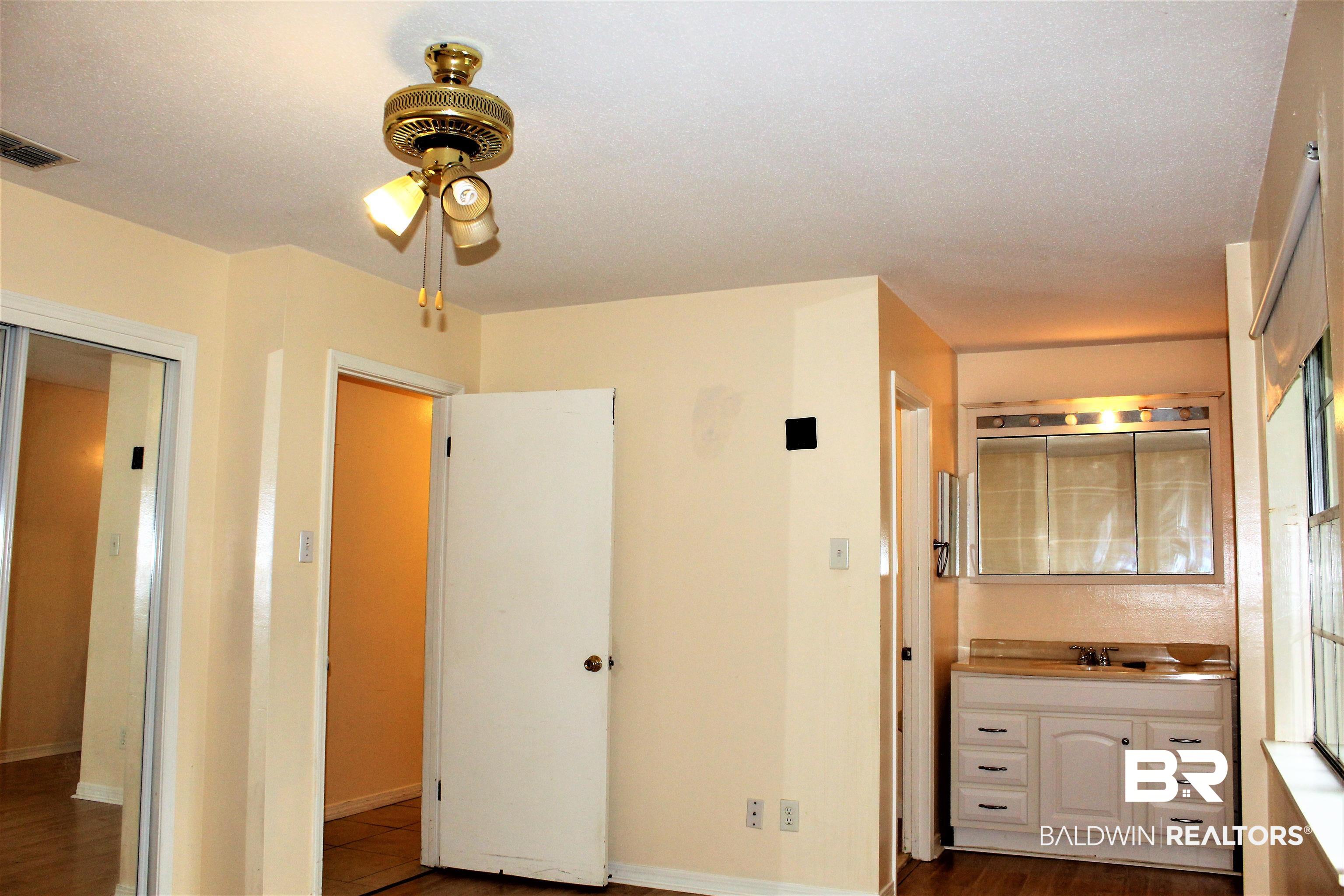 4251 Schillinger Road South Mobile, AL 36619 - Photo 15 of 38 Master suite w/vanity, bathroom, & double closets