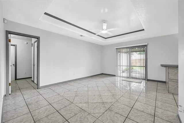 an empty room with a ceiling fan