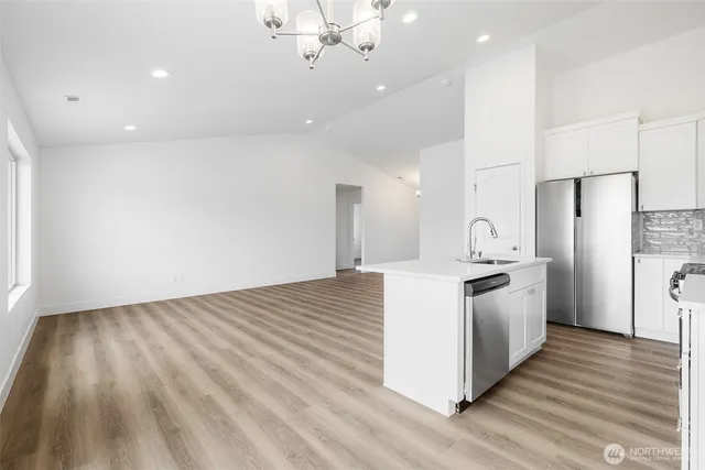 a large kitchen with a white stove top oven and refrigerator
