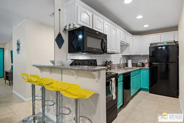 a kitchen with cabinets and stainless steel appliances