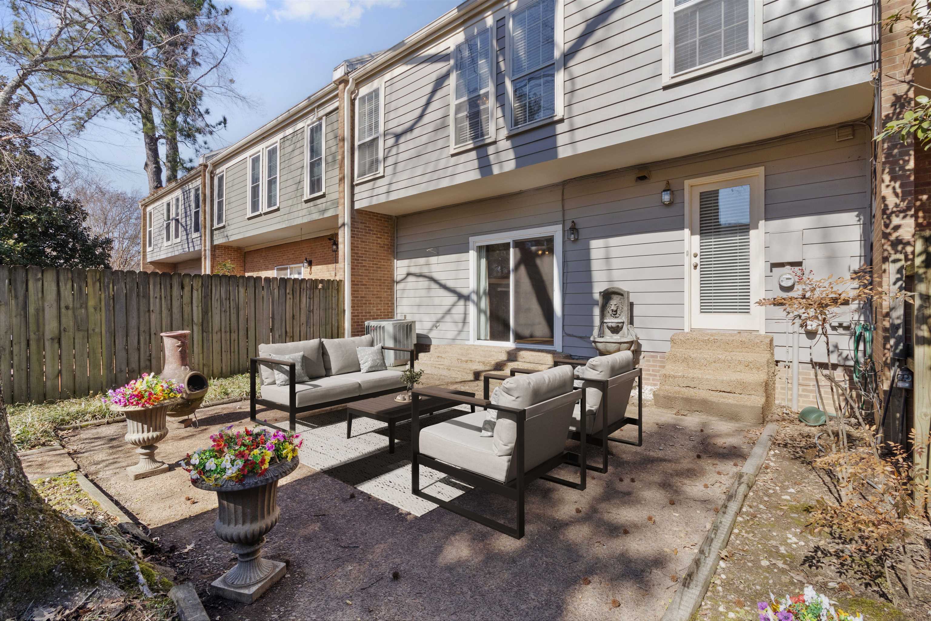 6905 Petworth Road, Unit 6905 Memphis, TN 38119 - Photo 1 of 32 a view of a patio with couches table and chairs and potted plants