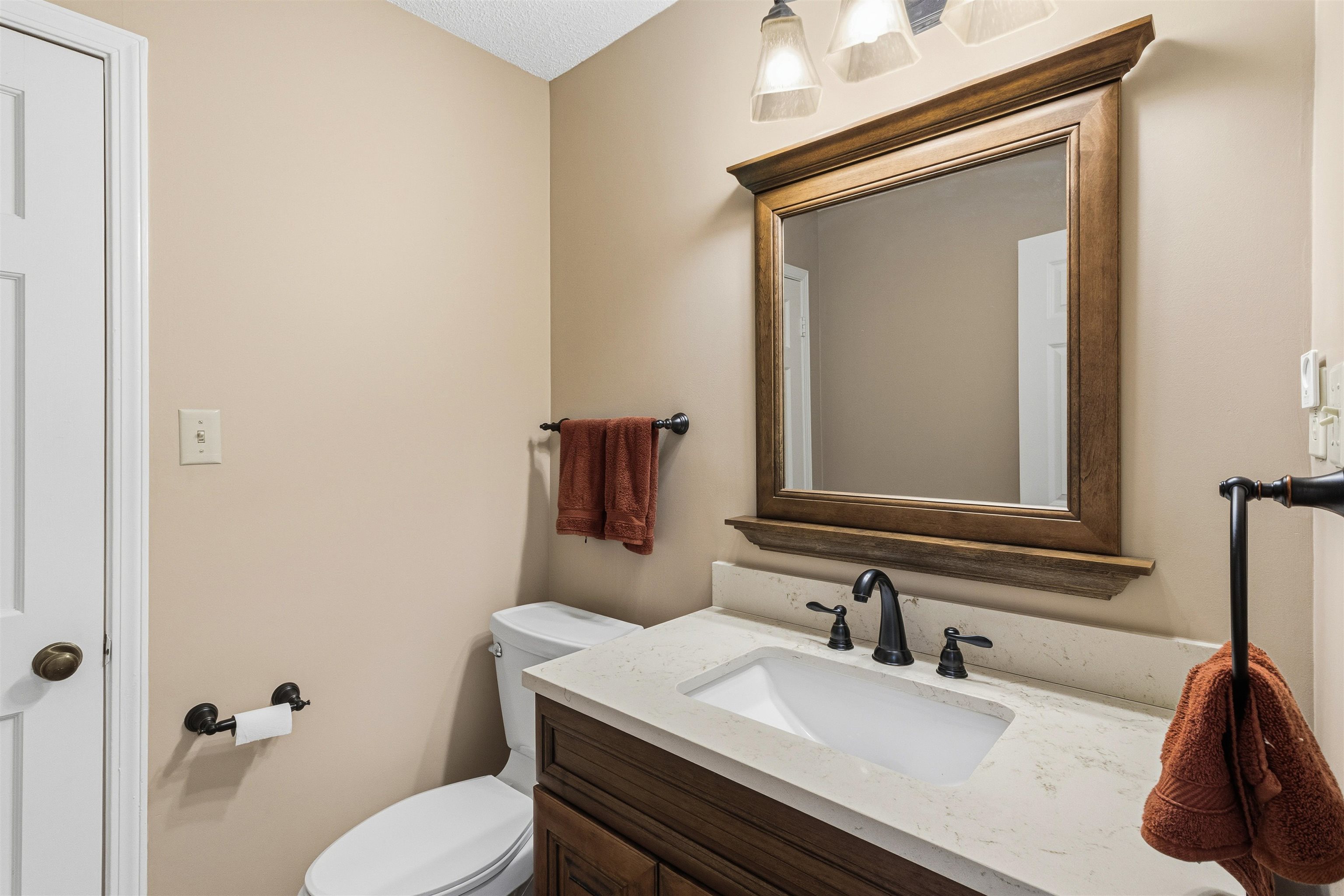 6905 Petworth Road, Unit 6905 Memphis, TN 38119 - Photo 13 of 32 a bathroom with a granite countertop toilet sink and mirror