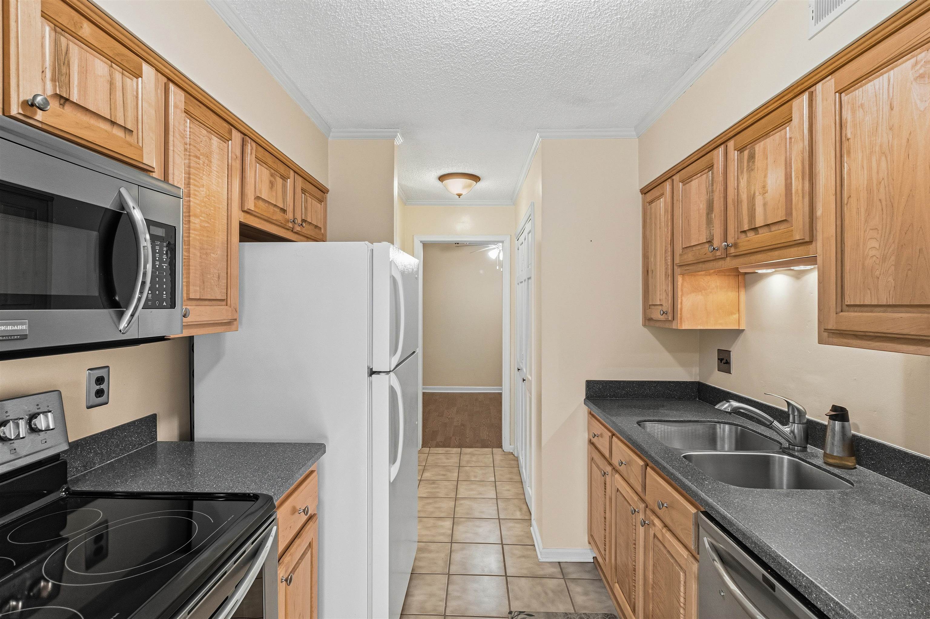6905 Petworth Road, Unit 6905 Memphis, TN 38119 - Photo 14 of 32 a kitchen that has a sink cabinets counter space and stainless steel appliances