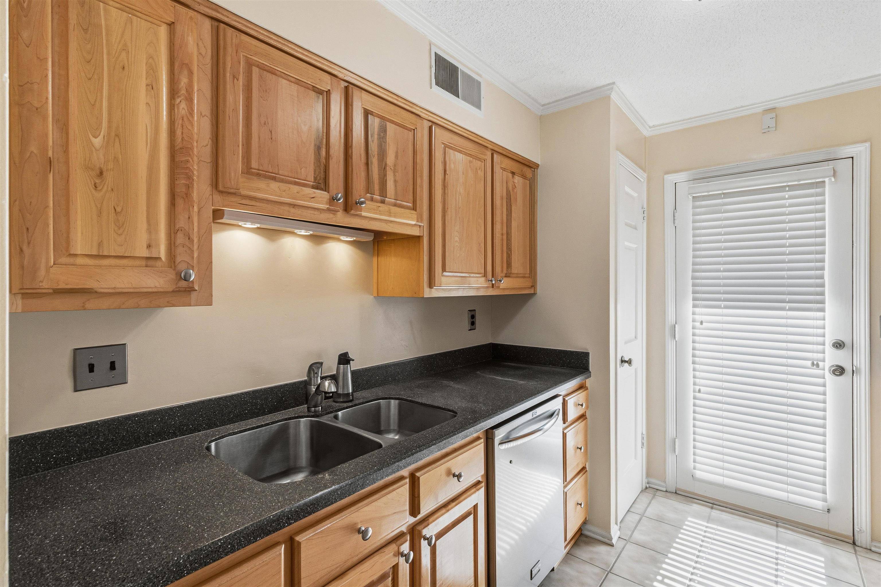 6905 Petworth Road, Unit 6905 Memphis, TN 38119 - Photo 17 of 32 a kitchen with stainless steel appliances granite countertop a sink and cabinets with wooden floor