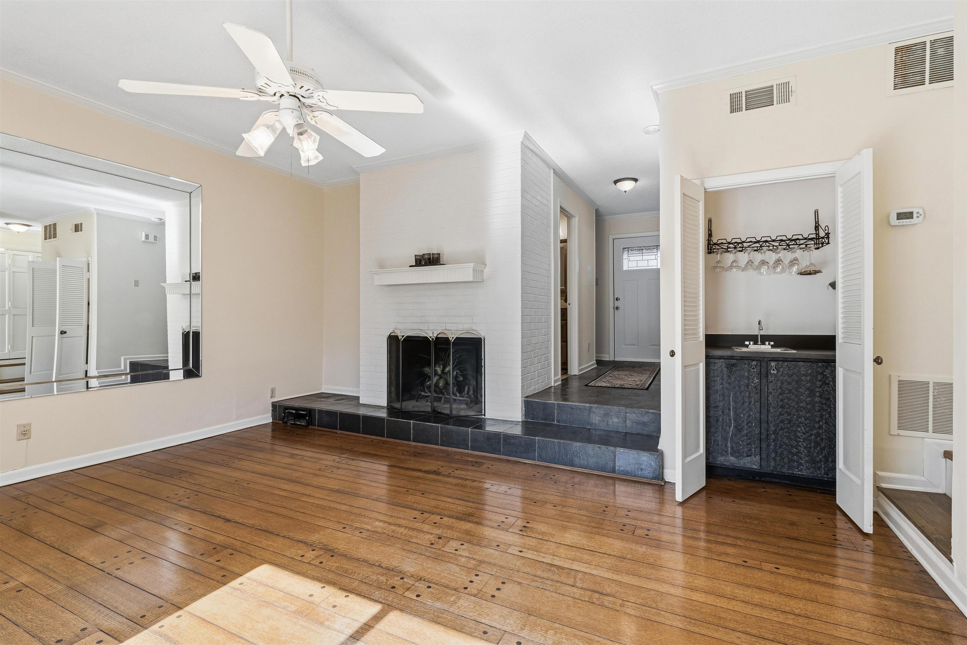 6905 Petworth Road, Unit 6905 Memphis, TN 38119 - Photo 18 of 32 a view of an empty room with wooden floor and a fireplace