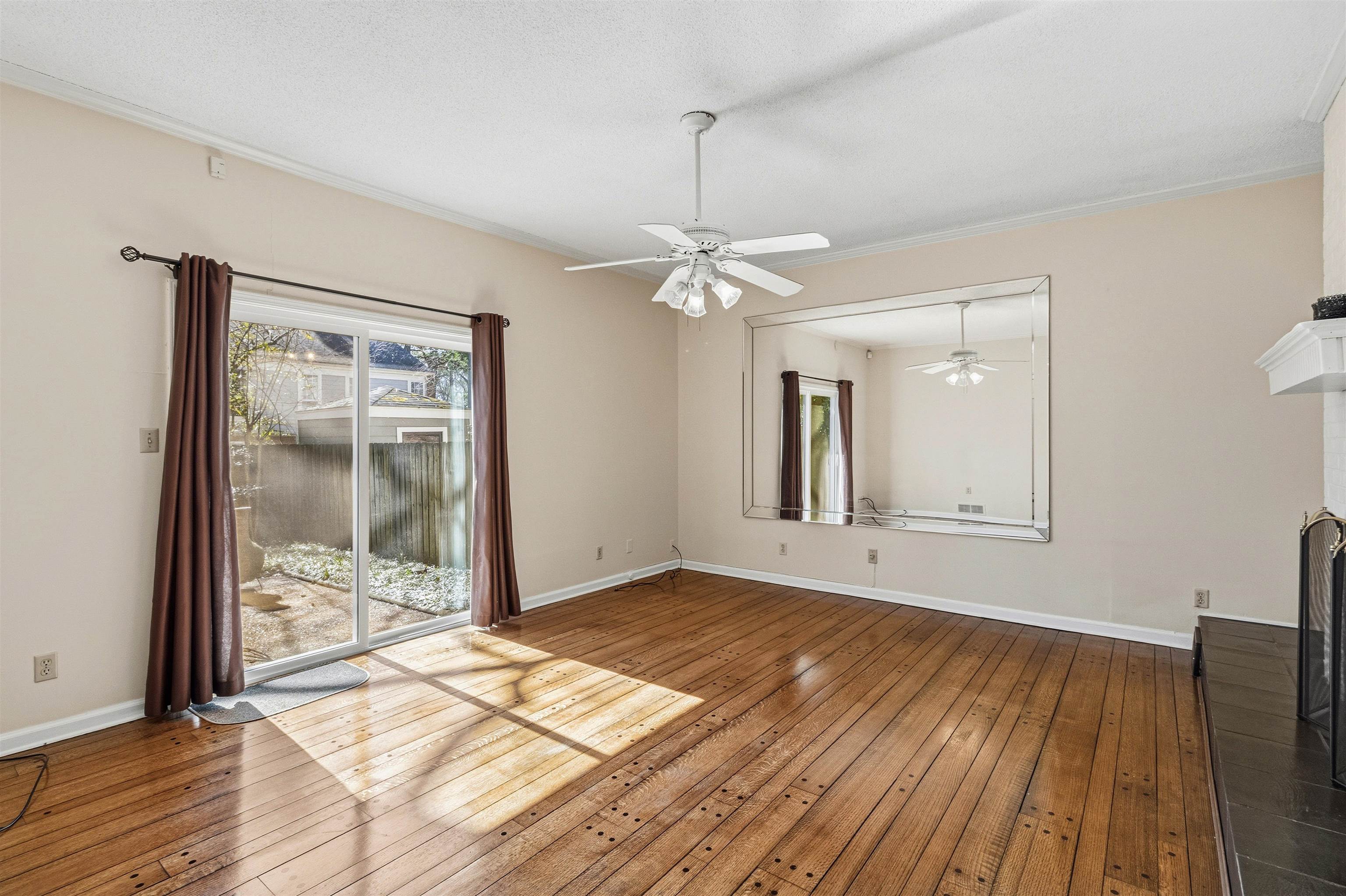 6905 Petworth Road, Unit 6905 Memphis, TN 38119 - Photo 20 of 32 a view of an empty room with wooden floor and a window