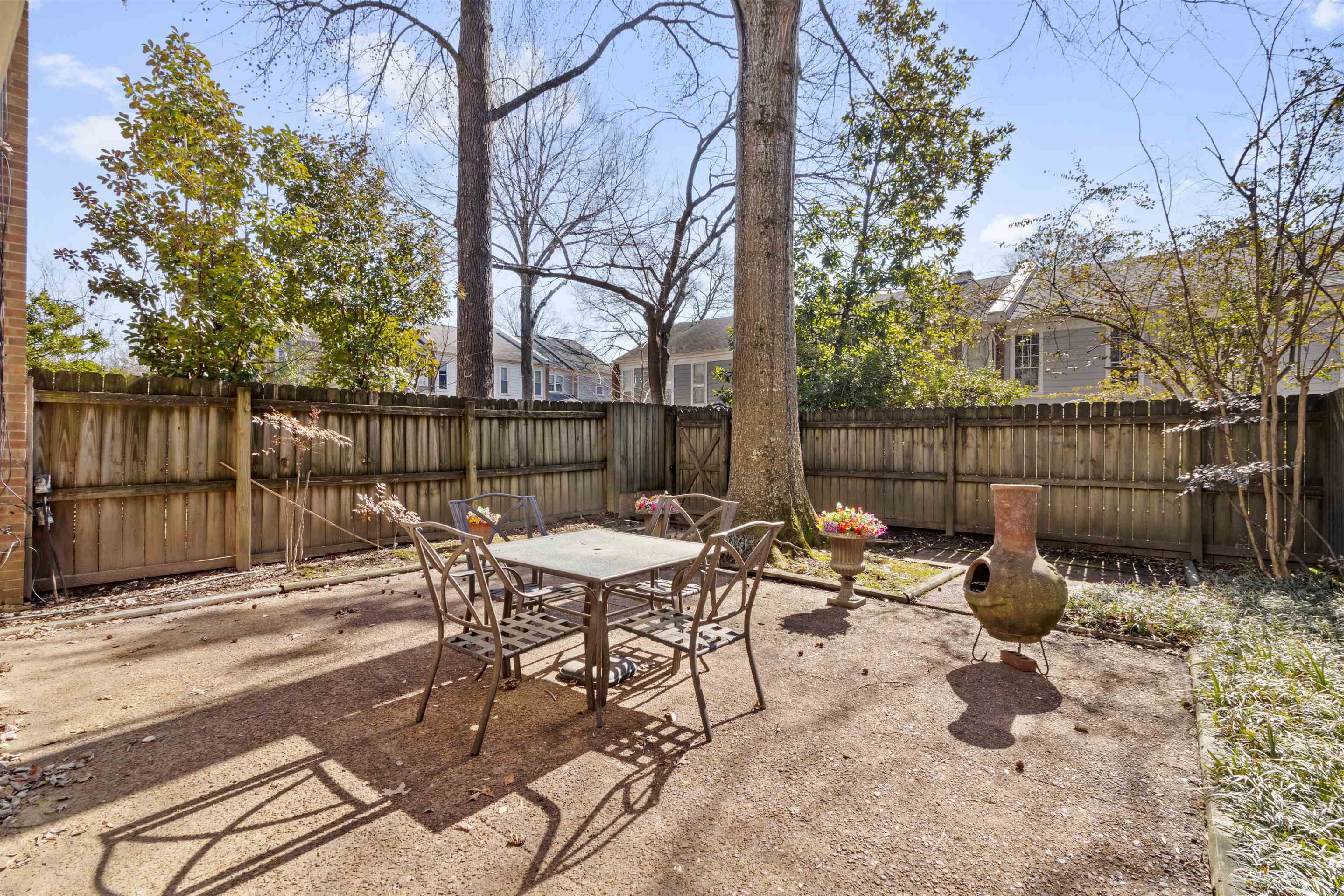 6905 Petworth Road, Unit 6905 Memphis, TN 38119 - Photo 29 of 32 a backyard of a house with table and chairs