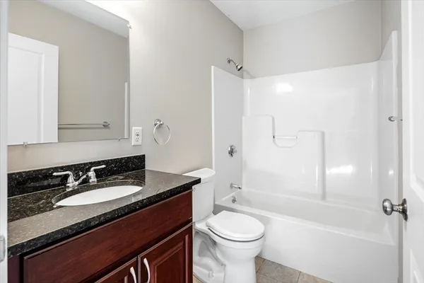 a bathroom with a sink a toilet a mirror and shower