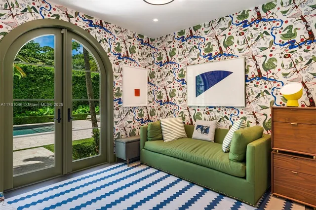 a living room with a couch and a floor to ceiling window