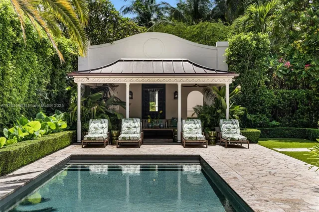 swimming pool view with a garden and plants