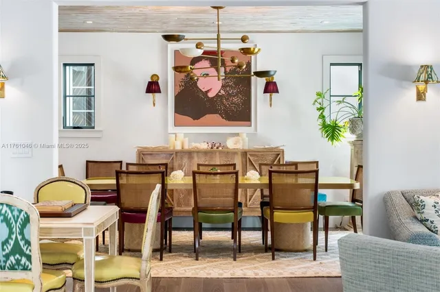 a dining room with furniture potted plants and wooden floor
