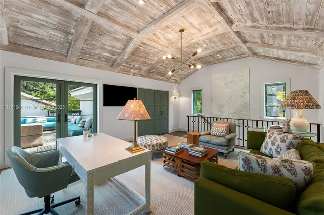 a view of a rooftop deck with couch and chairs