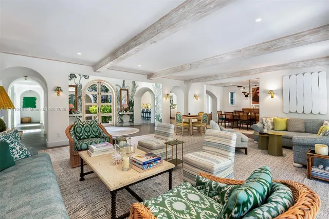 a living room with lots of furniture and view of kitchen