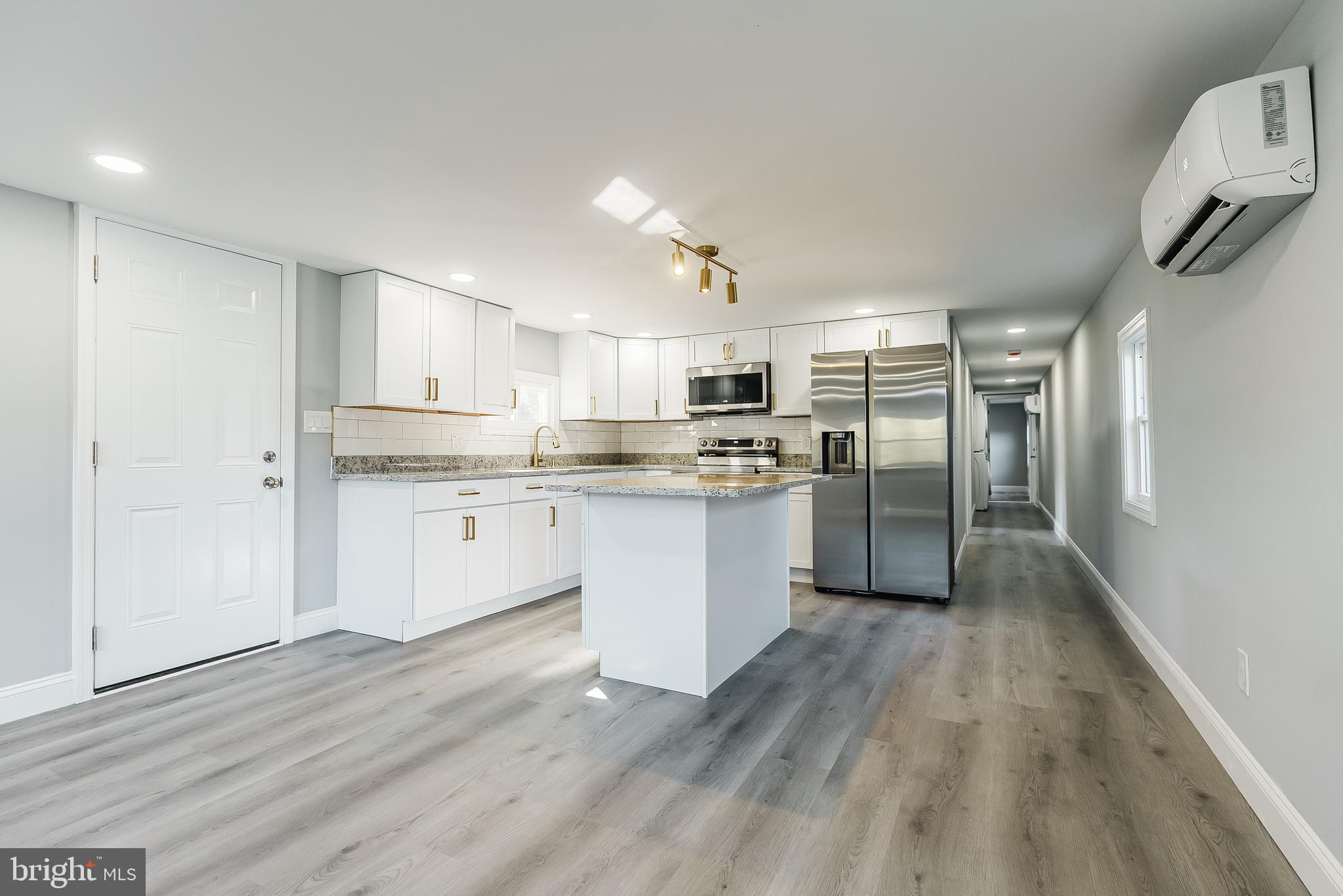 115 5th Street, Unit 31 Delaware City, DE 19706 - Photo 2 of 11 a kitchen with stainless steel appliances a refrigerator sink and cabinets