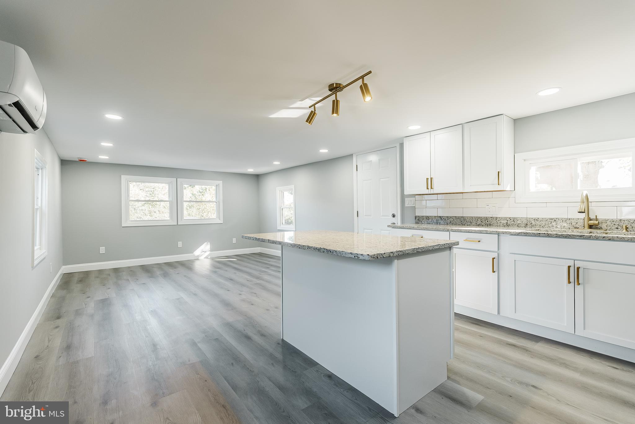 115 5th Street, Unit 31 Delaware City, DE 19706 - Photo 5 of 11 a view of a kitchen with a sink and dishwasher with wooden floor