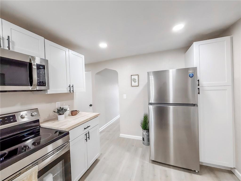 1529 Bower Hill Road Pittsburgh, PA 15243 - Photo 9 of 28 a kitchen with stainless steel appliances a refrigerator sink and microwave