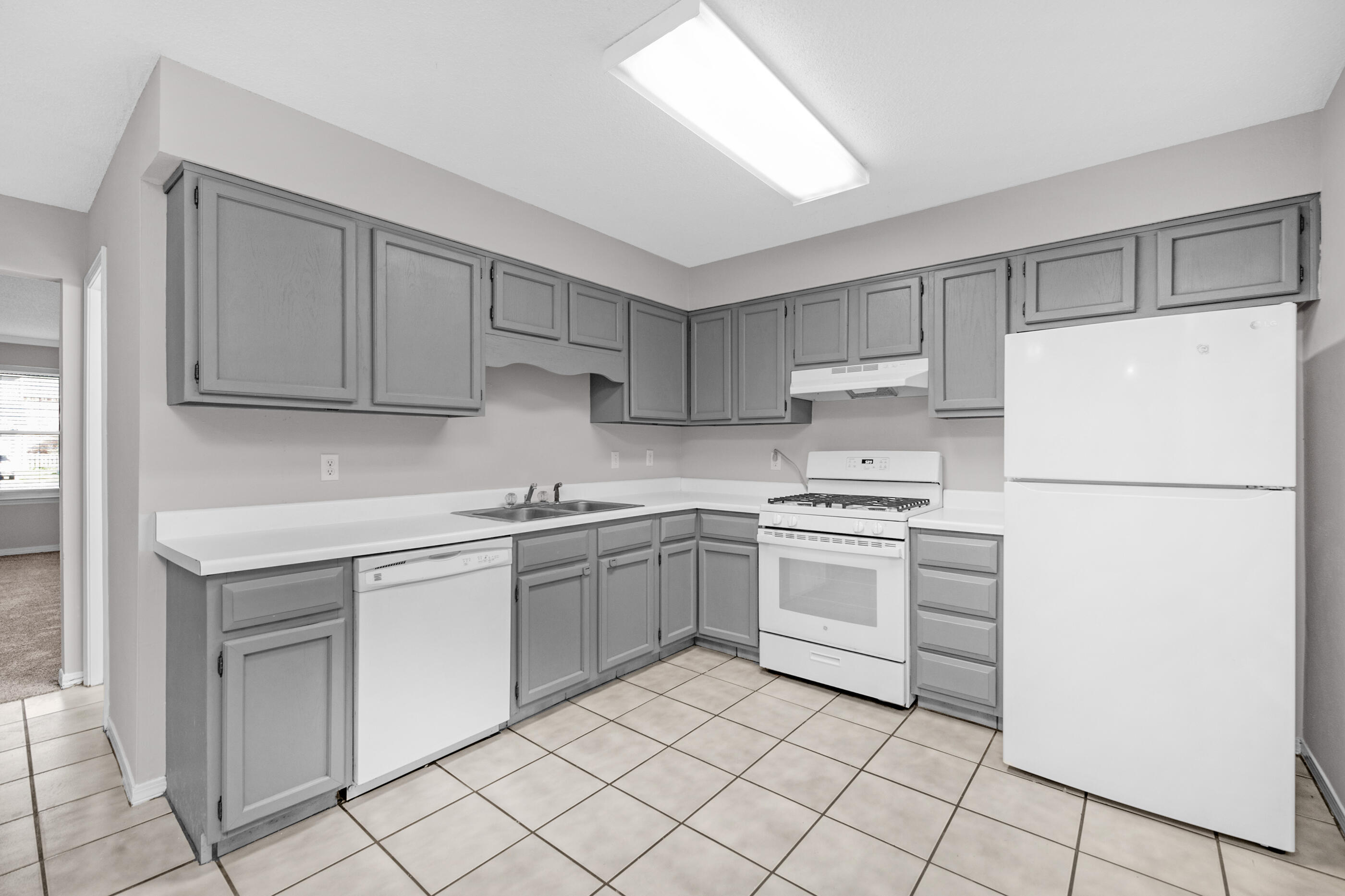106 4th Avenue Shalimar, FL 32579 - Photo 1 of 29 a kitchen with white cabinets and white appliances