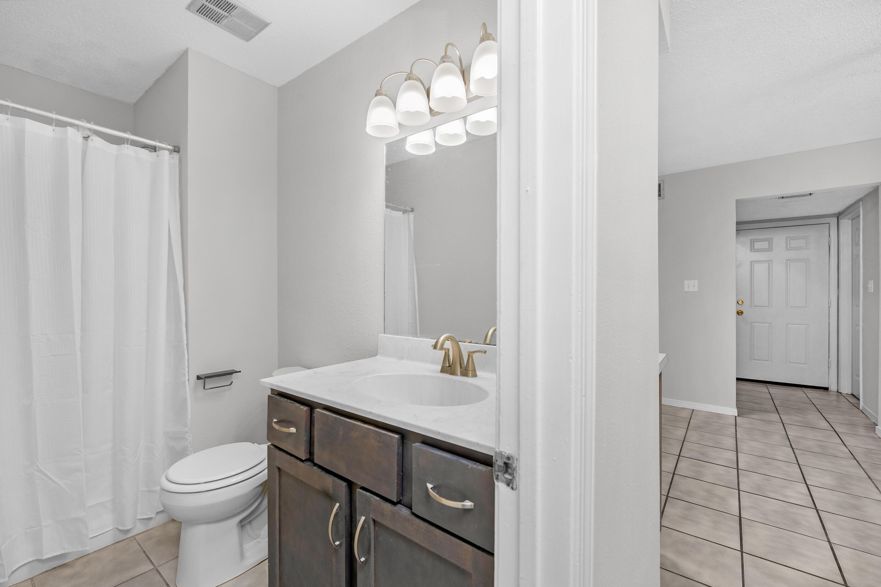 106 4th Avenue Shalimar, FL 32579 - Photo 12 of 29 a bathroom with a sink a toilet and a mirror