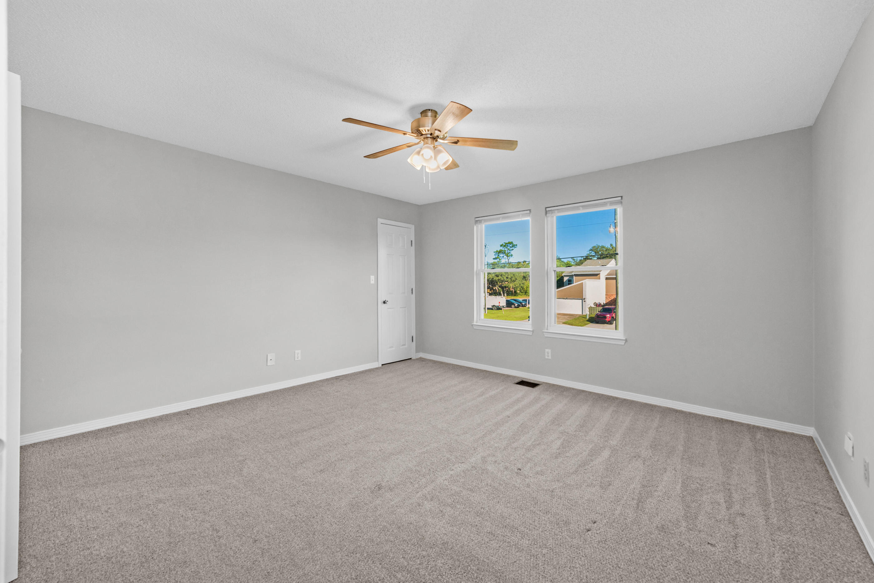106 4th Avenue Shalimar, FL 32579 - Photo 16 of 29 an empty room with windows and chandelier fan