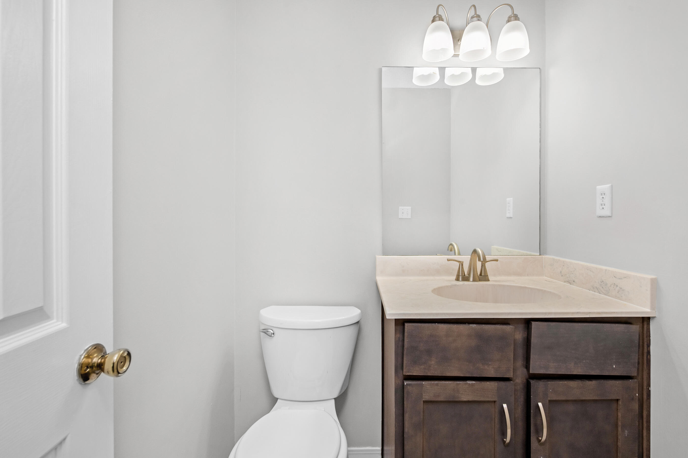 106 4th Avenue Shalimar, FL 32579 - Photo 17 of 29 a bathroom with a toilet a sink and mirror