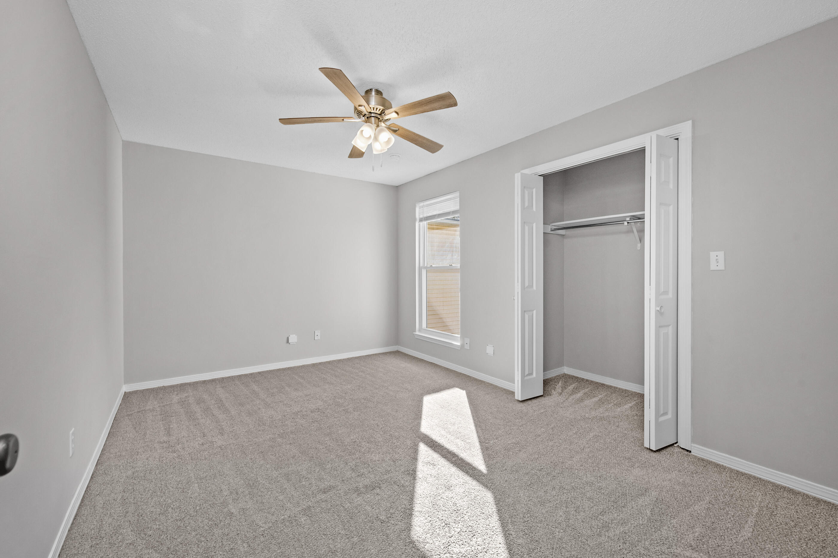 106 4th Avenue Shalimar, FL 32579 - Photo 20 of 29 an empty room with windows and fan