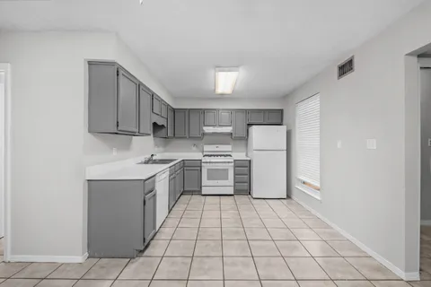 a kitchen with stainless steel appliances a refrigerator sink and cabinets