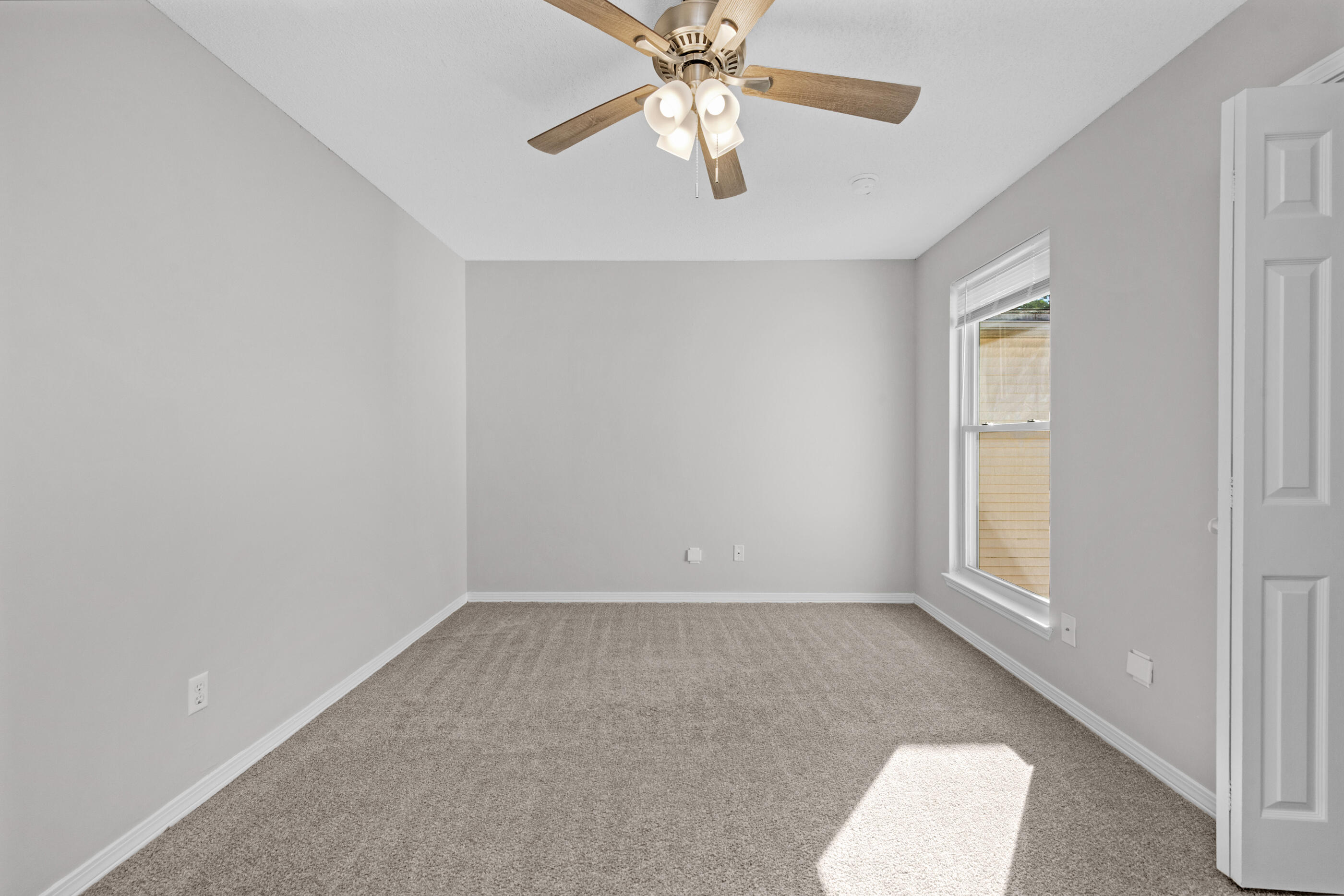 106 4th Avenue Shalimar, FL 32579 - Photo 21 of 29 an empty room with windows and fan