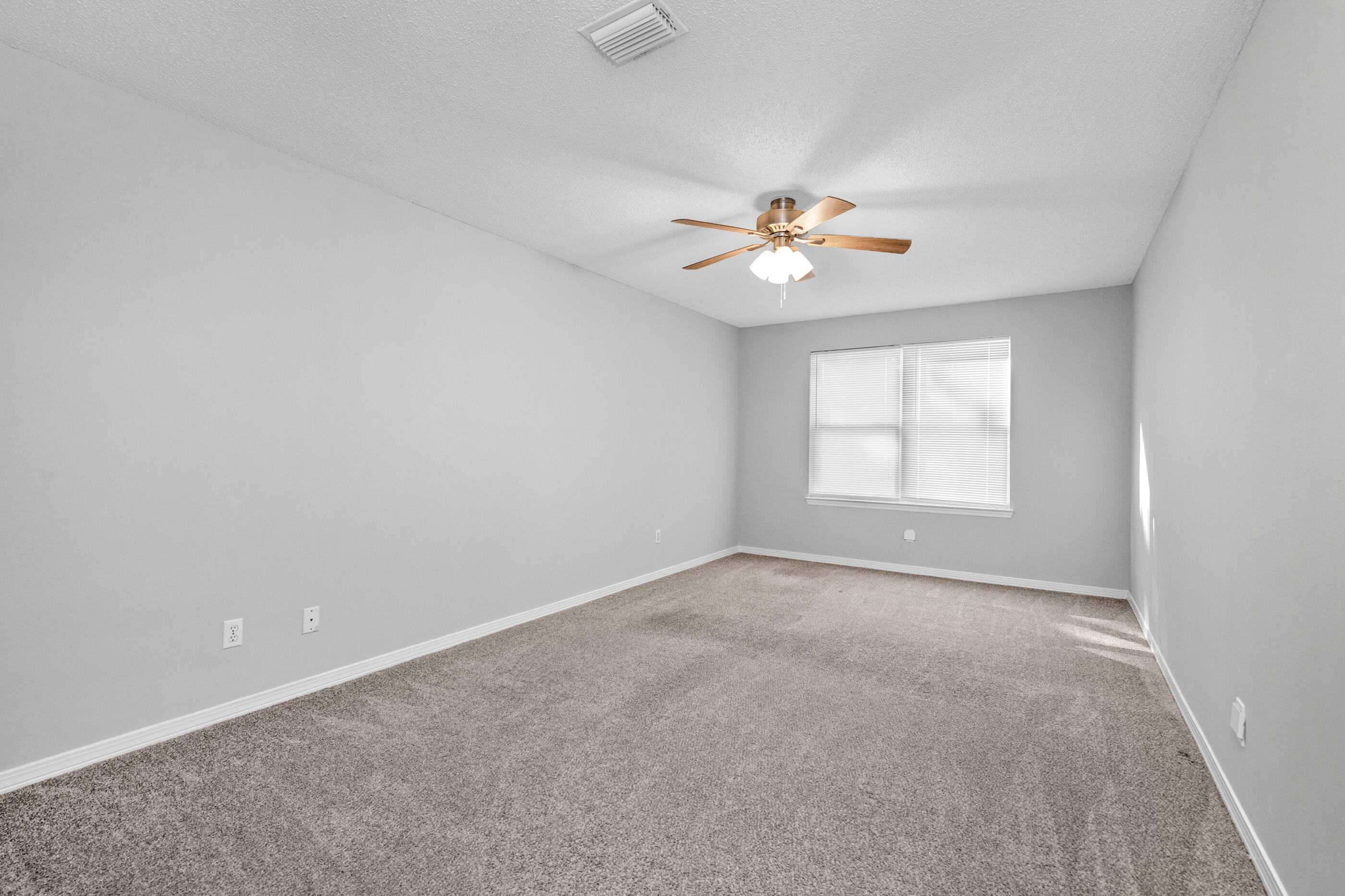 106 4th Avenue Shalimar, FL 32579 - Photo 22 of 29 an empty room with a window and a ceiling fan