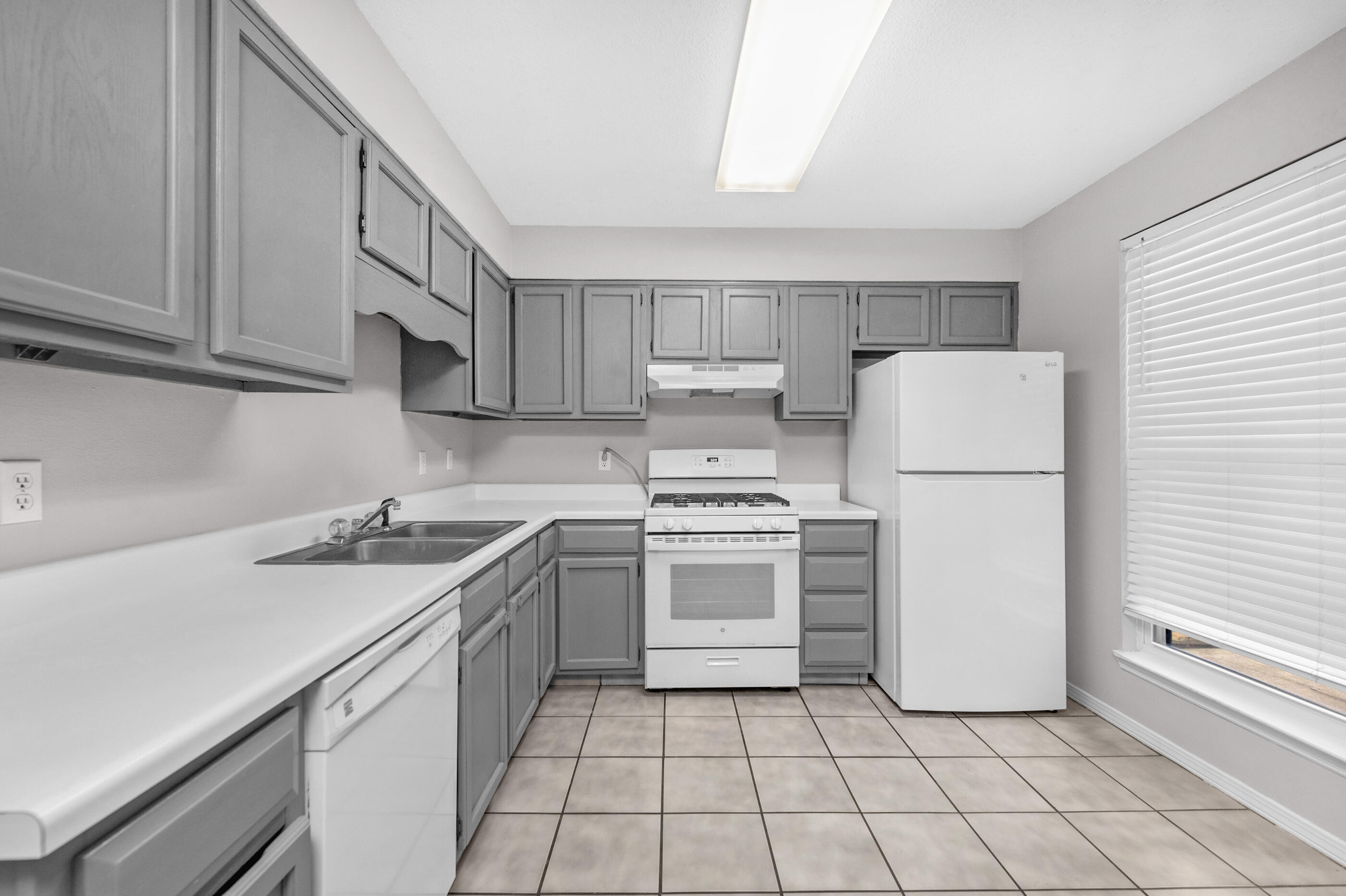 106 4th Avenue Shalimar, FL 32579 - Photo 4 of 29 a kitchen with a sink a refrigerator and cabinets