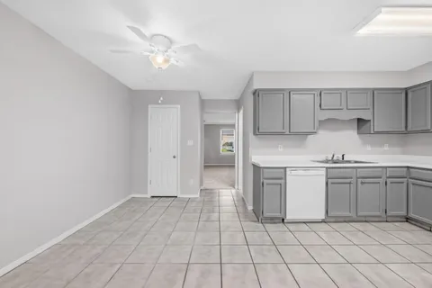 a kitchen with white cabinets