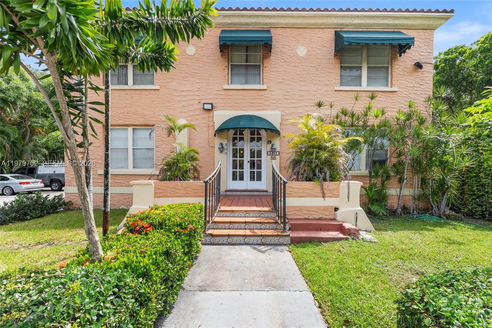 3409 South Le Jeune Road Coral Gables, FL 33134 - Photo 2 of 53 a front view of a house with a yard