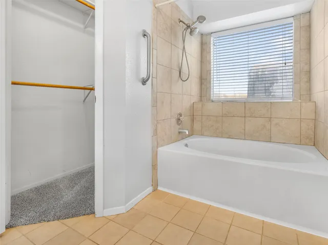 a bathroom with a bathtub and shower
