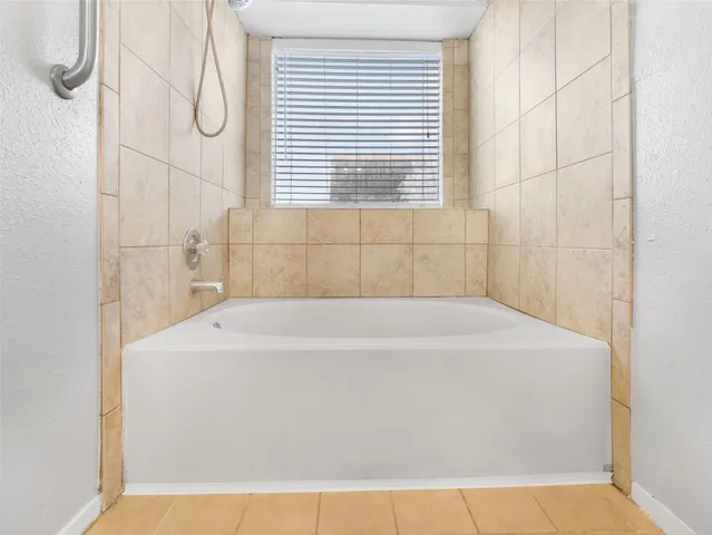 a white bath tub sitting next to a window