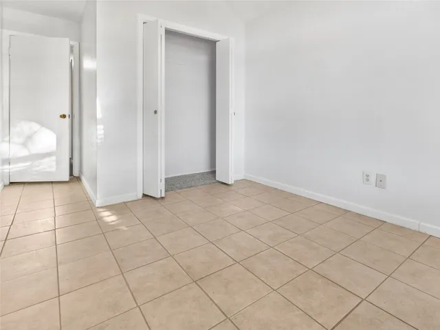 a view of an empty room and wooden floor