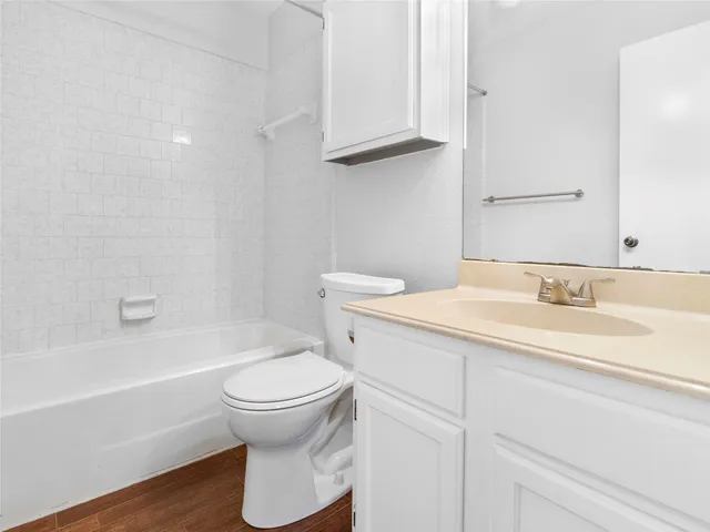 a bathroom with a sink a toilet and a bathtub